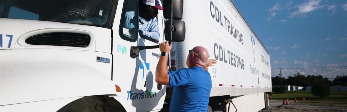 Instructor teaching student in truck driver training program