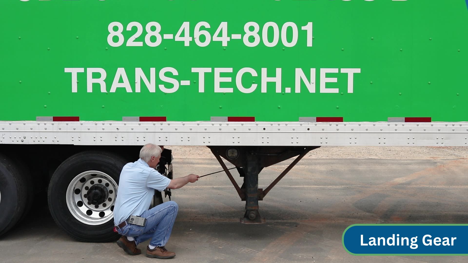 instructor pointing at landing gear under trailer