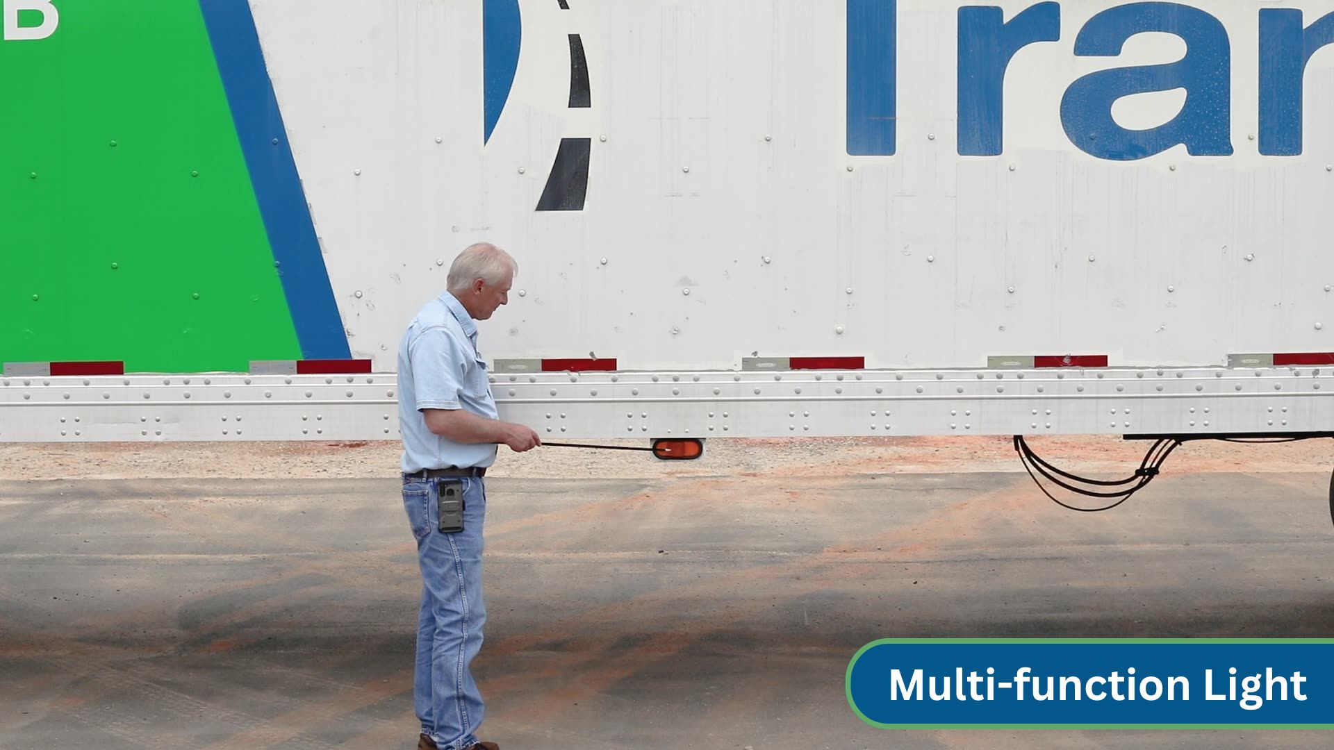 instructor pointing at multifunction light on side of trailer