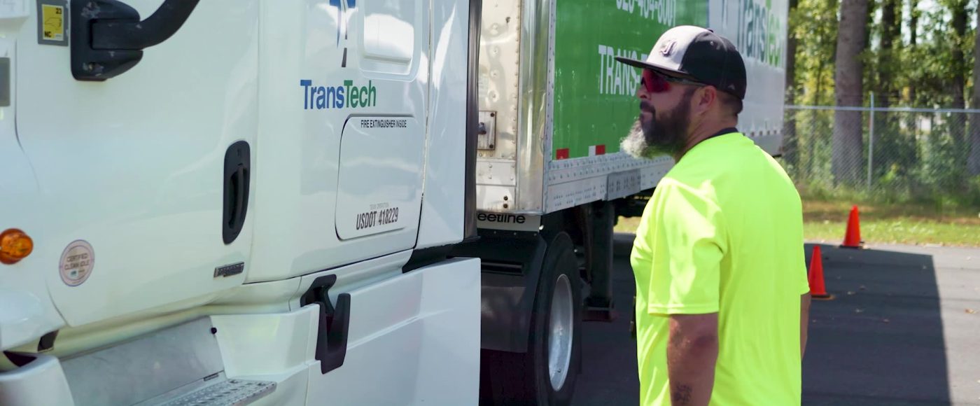 image of instructor working with a cdl student in the training yard.