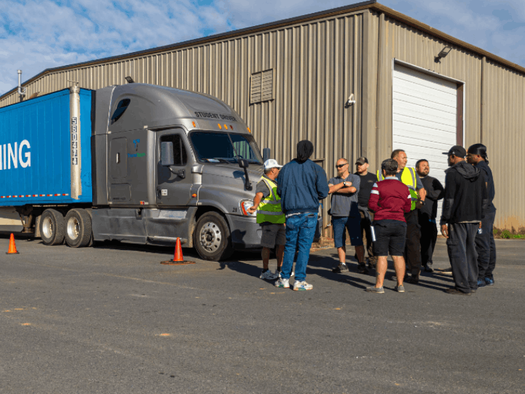 Students standing around a parked TransTech semi truck