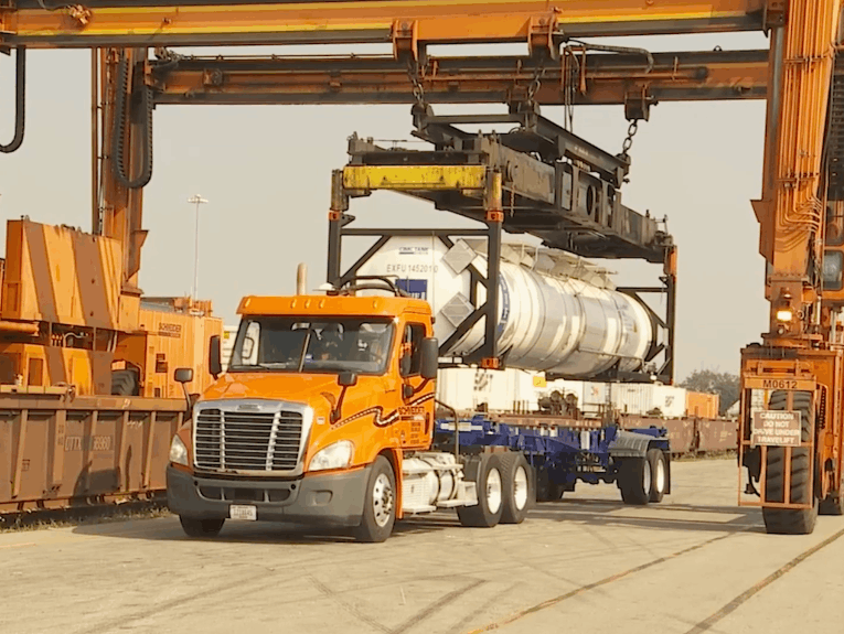 Schneider truck being loaded with a tank