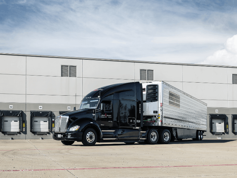 Stevens Transport reefer truck parked in front of warehouse