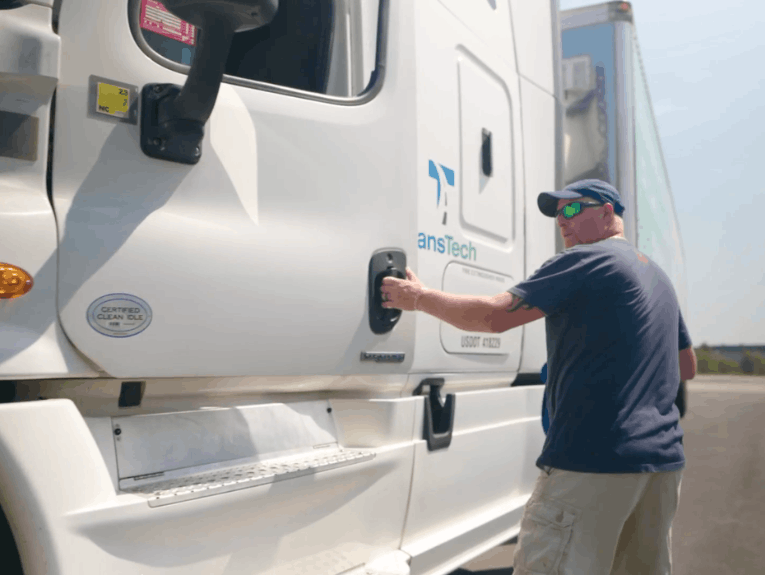 Instructor opening door of TransTech semi truck cab