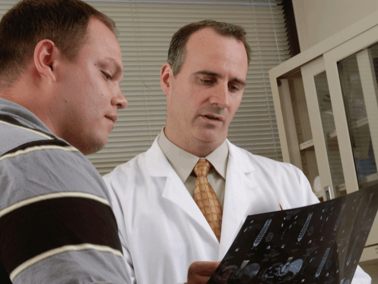 Doctor showing patient clipboard with exam information