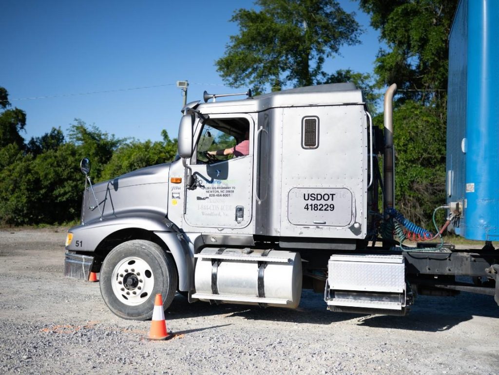 Front cab of Charleston semi truck in a gravel training yard