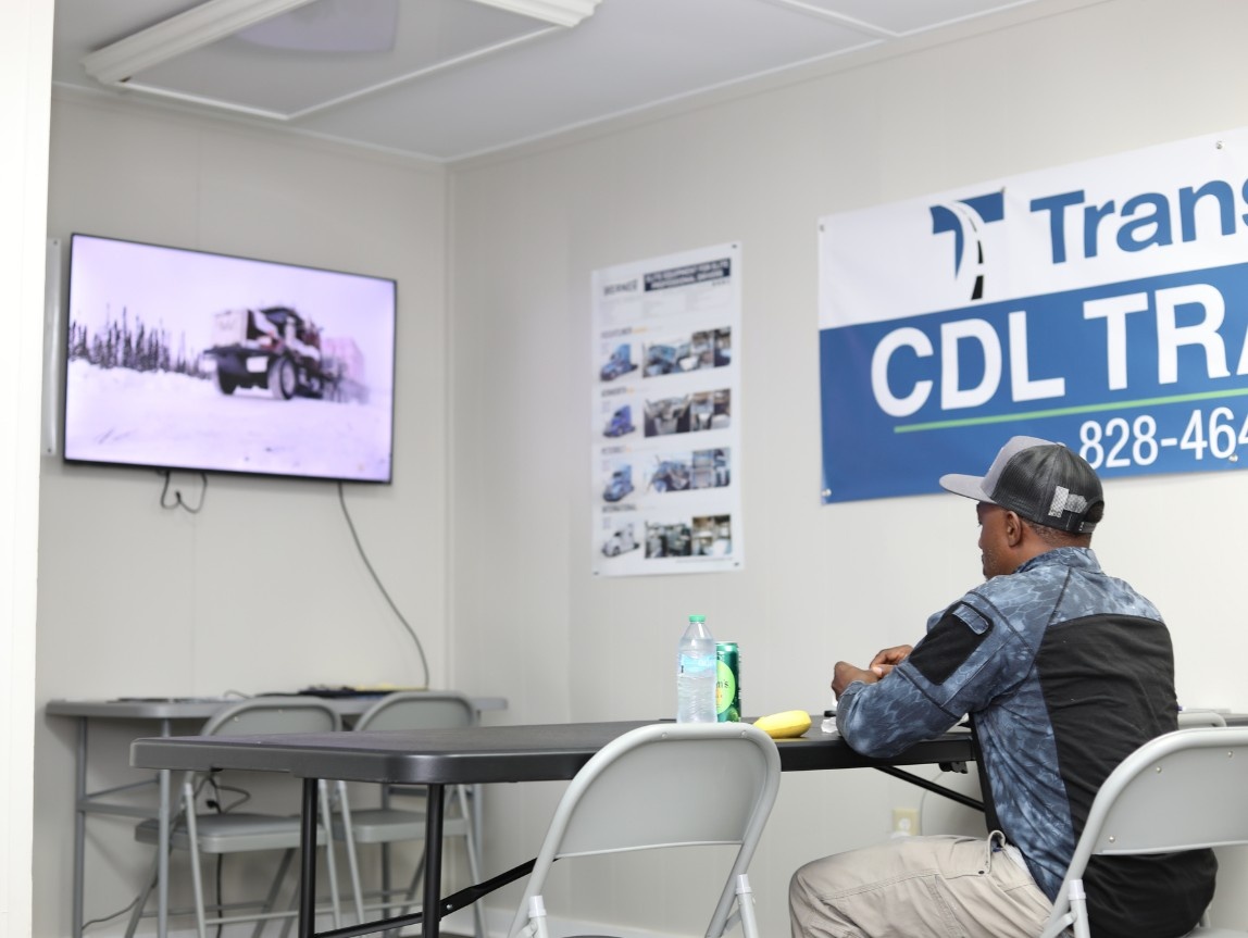 CDL student studying for a truck driving permit test in a TransTech CDL training classroom