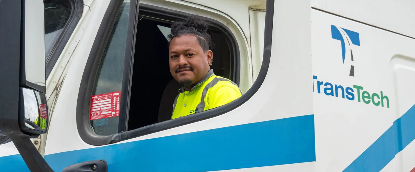 TransTech student smiling and climbing into semi truck