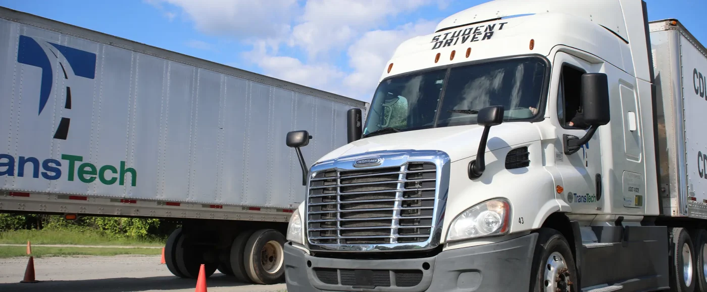 TransTech semi truck parked next to a trailer