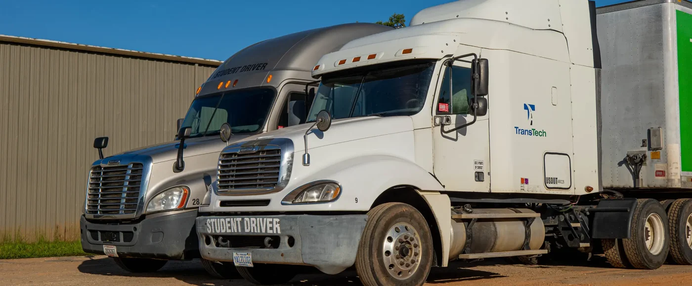 Two TransTech semi trucks parked side-by-side