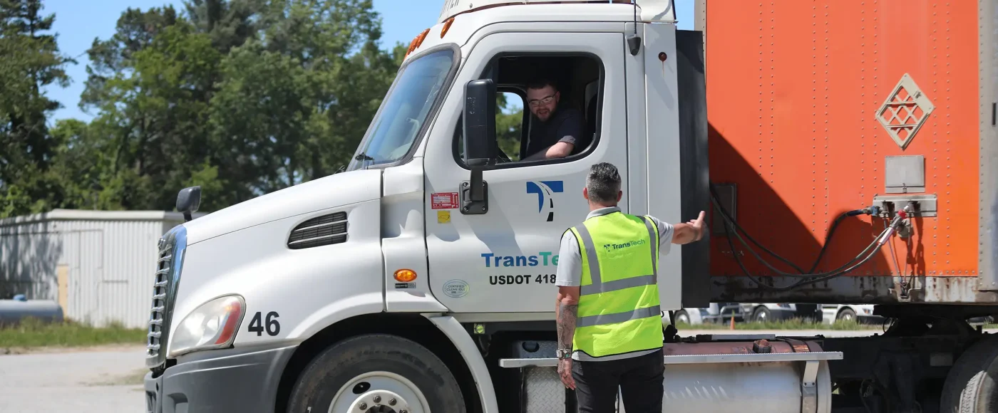 Instructor speaking to student through the semi truck window